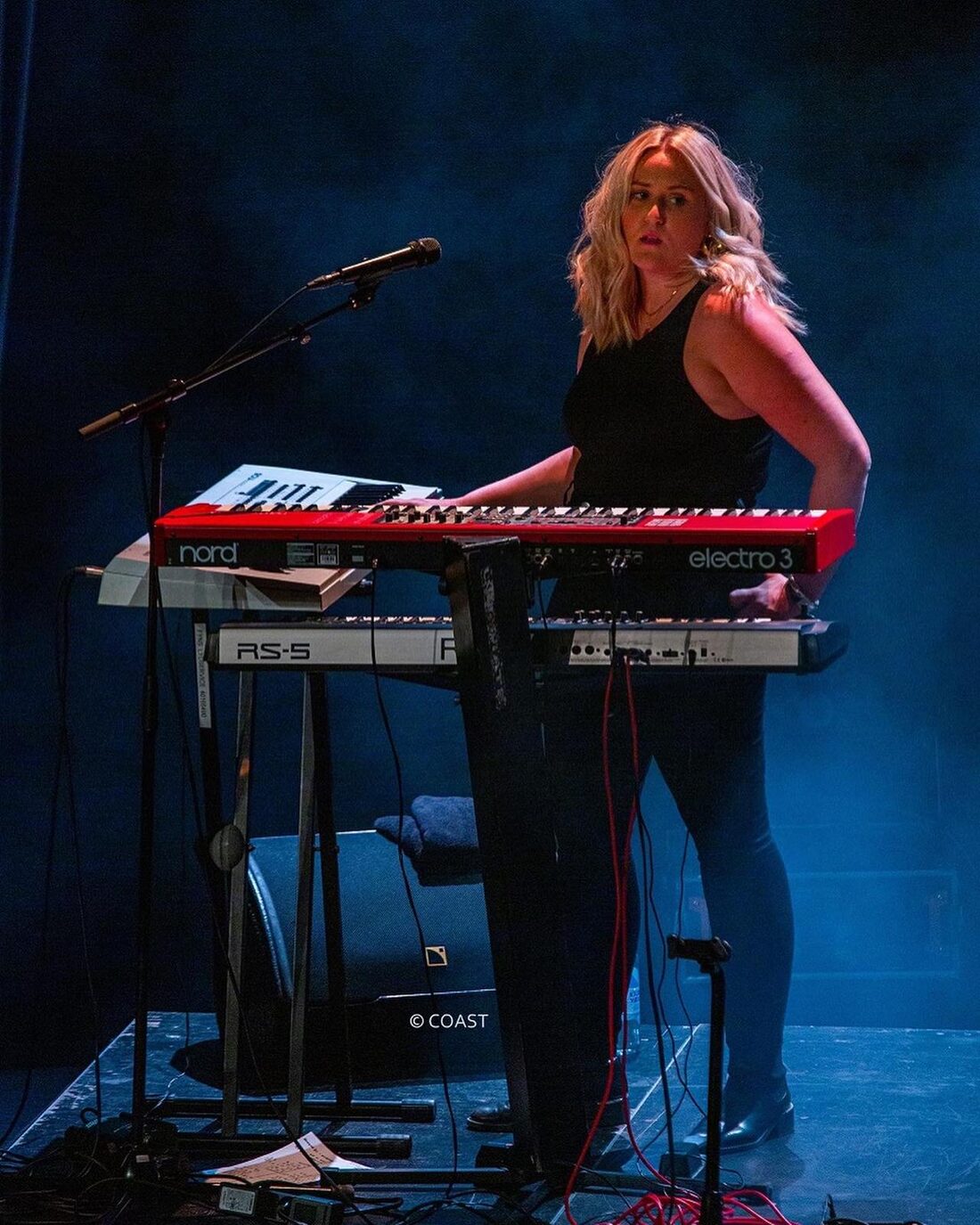 Georgie on keys and vocals on stage with Coast